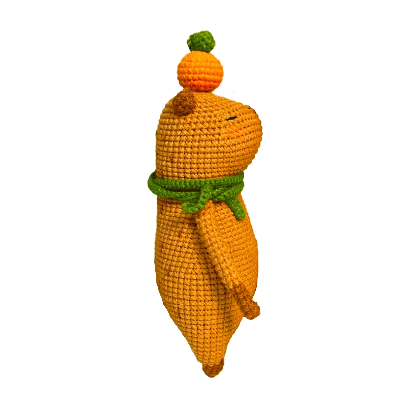 Colorful crochet doll keychain hanging on geometric black and white handbag capybara amigurumi pattern