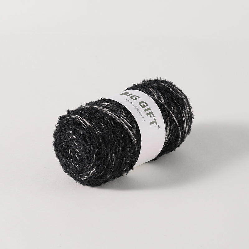 Black yarn skein with white label featuring artisan wool blend for crochet by 不二手作 accessories