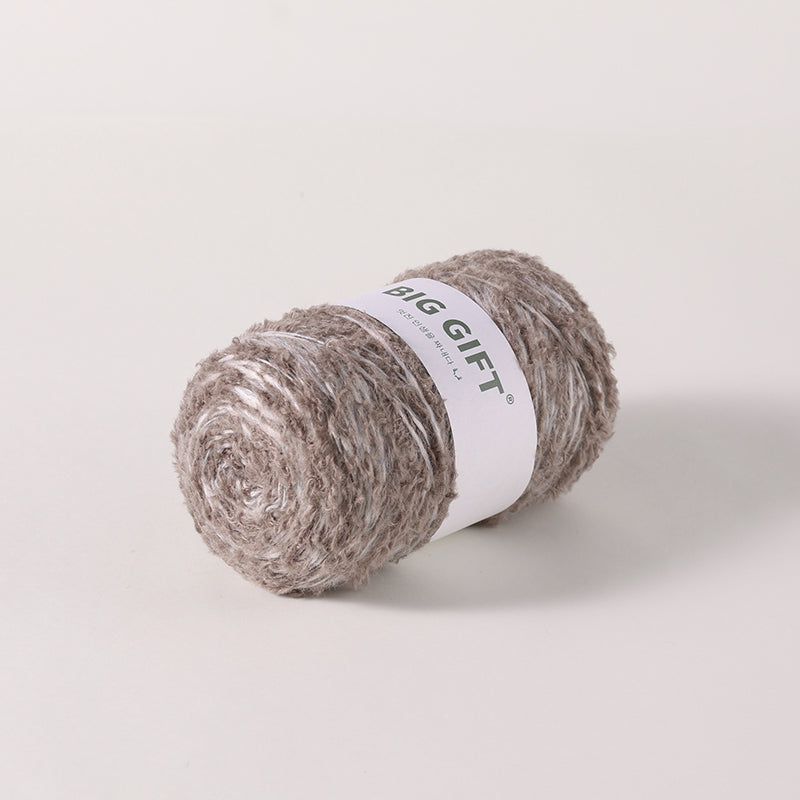 Artisan wool blend for crochet yarn in a soft grayish brown color with textured fibers