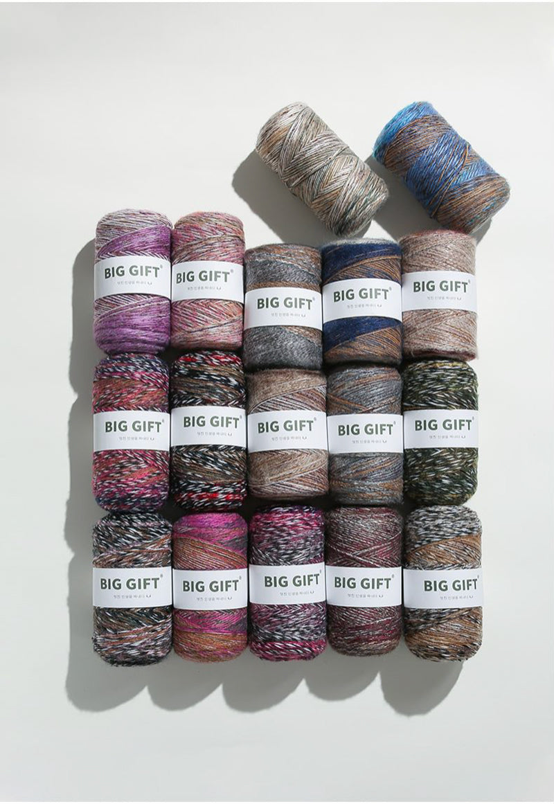 Assorted colorful yarn skeins labeled Big Gift made from artisan wool blend for crochet accessories