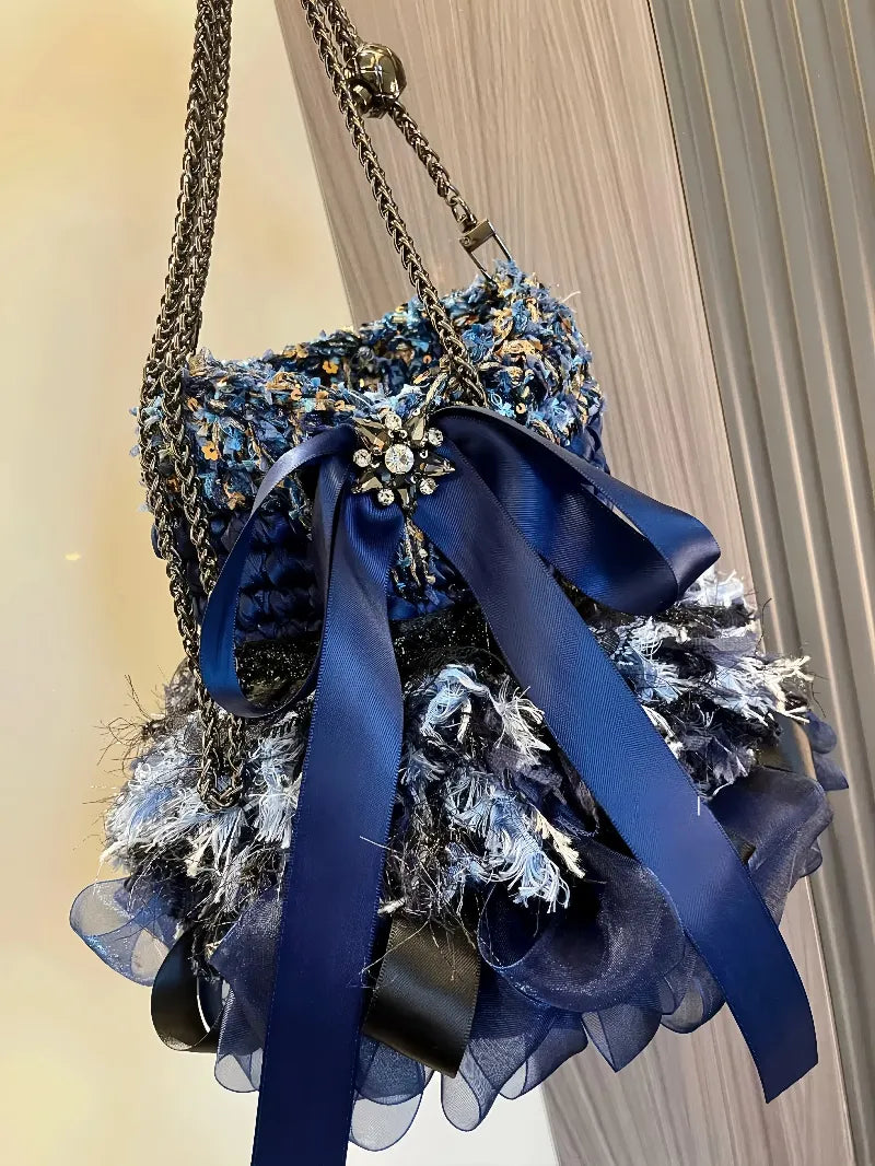 Redbook crochet diagram showing a blue crochet handbag pattern with decorative chains and ribbon