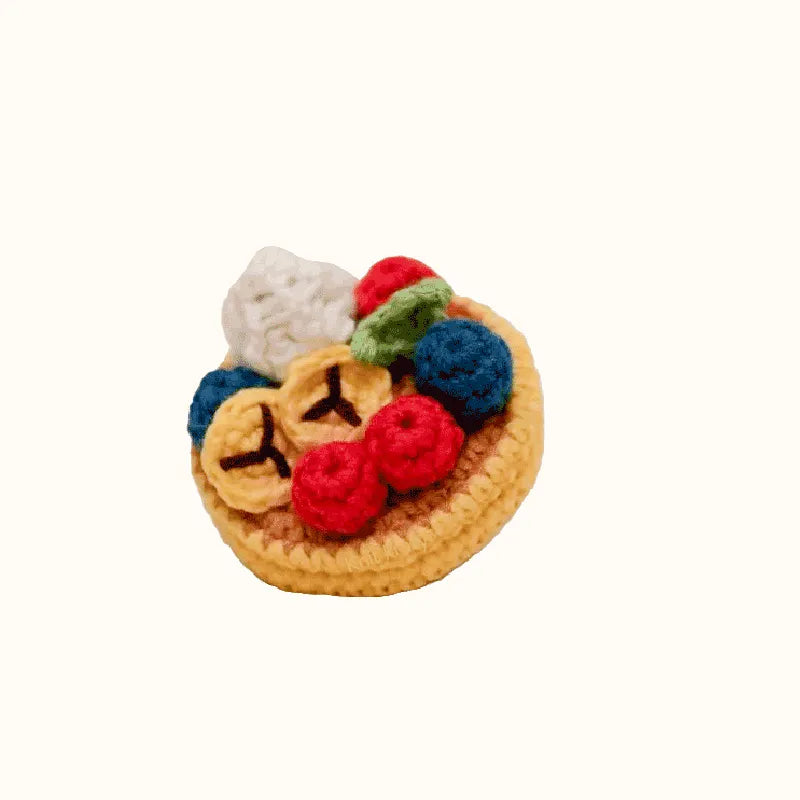 Crochet fruit pancake pattern featuring colorful crocheted berries and banana slices on a pancake base