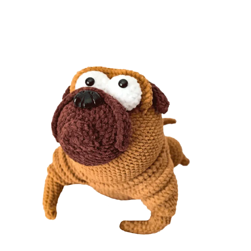 Handmade crochet pug doll using crochet pug doll pattern with brown and tan yarn details
