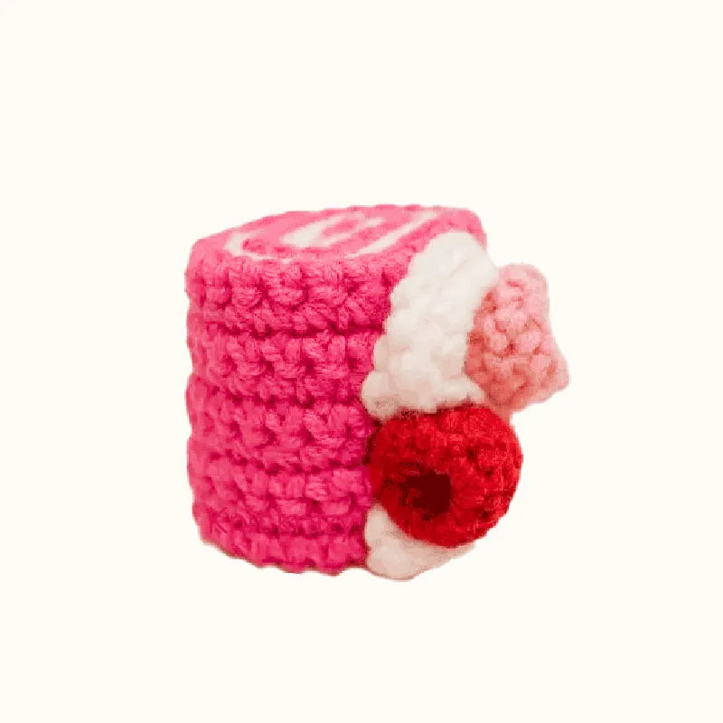 Handmade crochet raspberry swiss roll pattern featuring vibrant pink and red yarn with detailed stitches