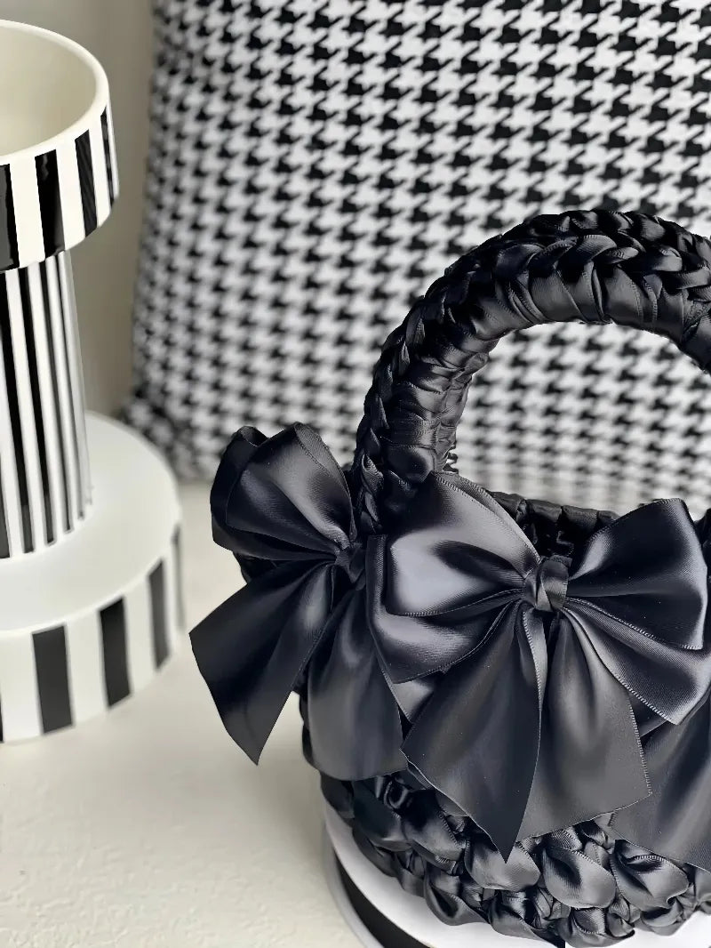 Black crocheted purse with satin bows featuring a DIY bow adorned purse design by redbook