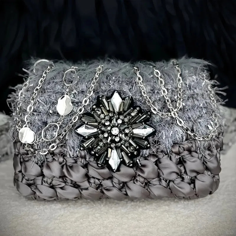 Galactic inspired purse pattern crochet diagram featuring a textured gray purse with silver chain and gemstone brooch