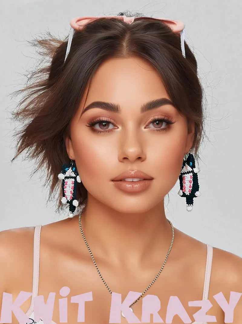 Fashionable woman wearing handmade cat earrings with black, white, and pink beadwork from vendor 小黄香蕉