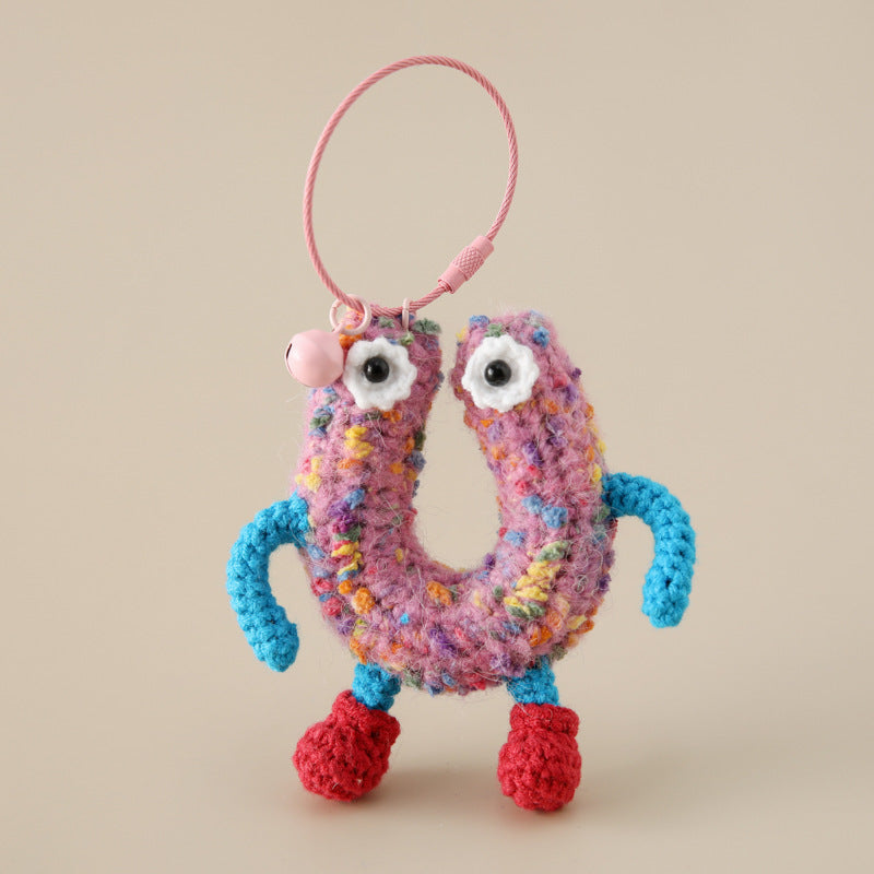 Colorful handmade crocheted letter keychain with eyes blue arms and red feet charm