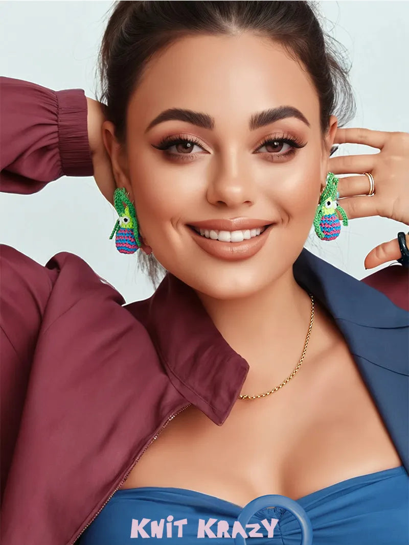 Smiling woman wearing colorful handmade spider web earrings with knit detailing from The Knit Krazy