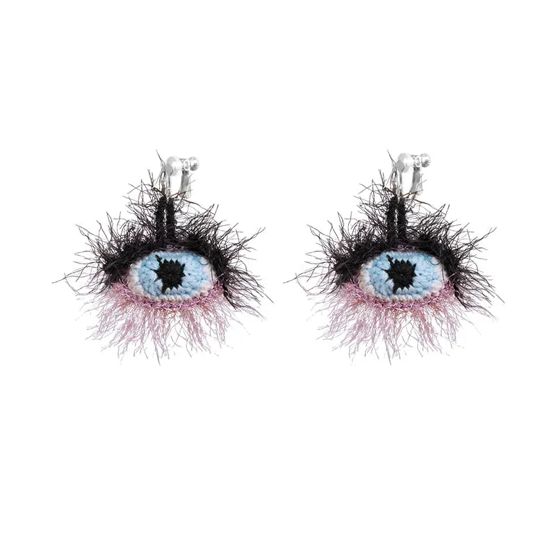 Colorful handmade surrealist eye earrings with intricate beaded design and clip-on backs