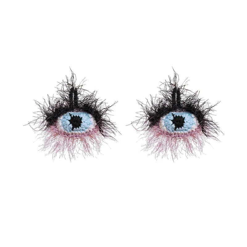 Small yellow banana handmade surrealist eye earrings with black fuzzy lashes and blue iris design