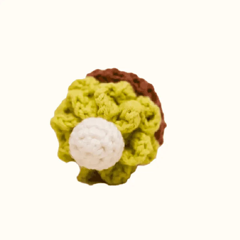 Crochet matcha cake pattern with green and brown yarn and white cream decoration by The Knit Krazy