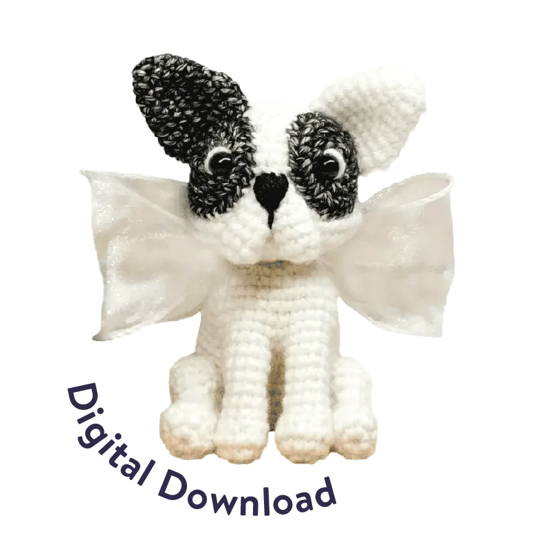 Crochet French bulldog pattern amigurumi with black and white yarn and decorative wings