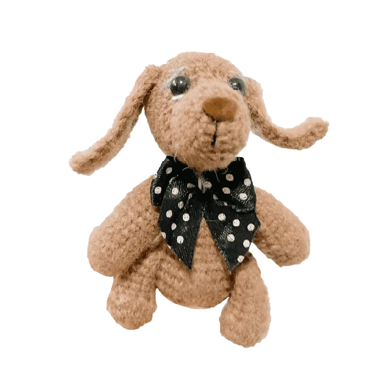 Redbook mini crochet puppy pattern with brown yarn and black polka dot bow tie