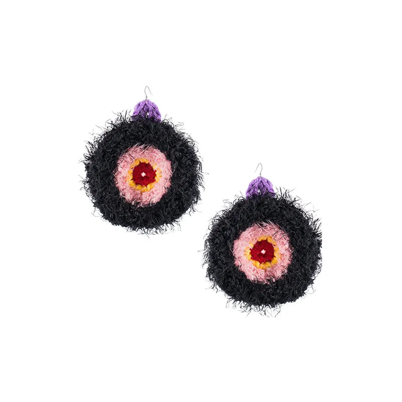 Unique handmade earrings featuring black fuzzy circular design with pink and red center and purple hook