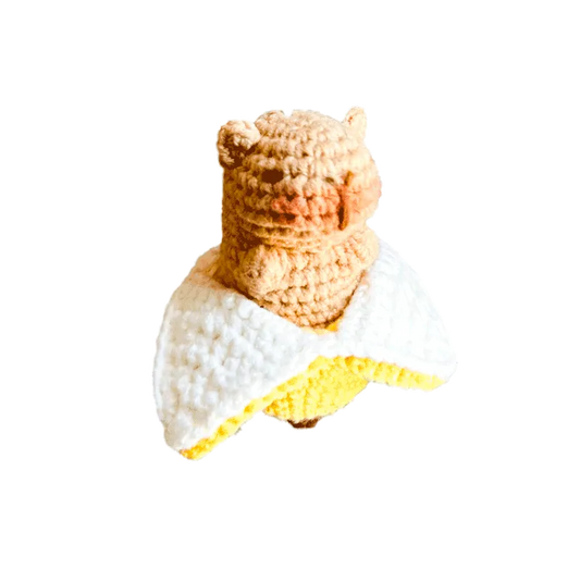 Cute beige crochet bear wrapped in a white and yellow banana amigurumi crochet pattern peel