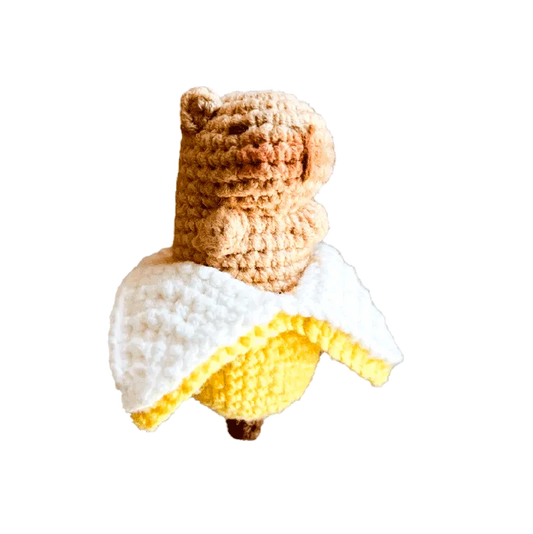 Handmade banana amigurumi crochet pattern featuring a cute crocheted bear wrapped in a peeled banana