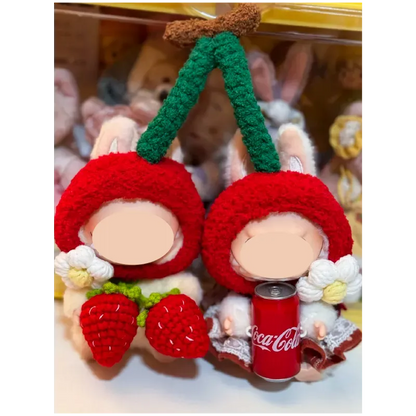 Cherry-themed crochet outfit for plushies featuring red cherry hats and decorative white flowers