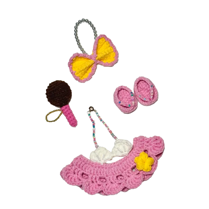 Set of collectible crochet doll patterns featuring pink skirt, yellow bow, pink shoes, and accessories