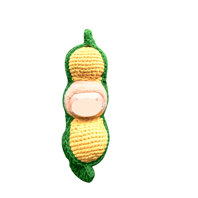 Creative crochet carrier for dolls shaped like a green and yellow peanut pod with soft texture
