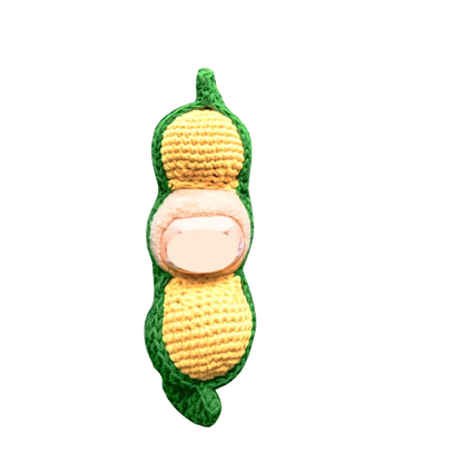 Creative crochet carrier for dolls shaped like a green and yellow peanut pod with soft texture