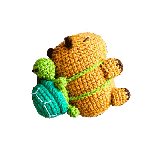 Handmade crochet capybara keychain pattern featuring a capybara with a small green turtle on its back