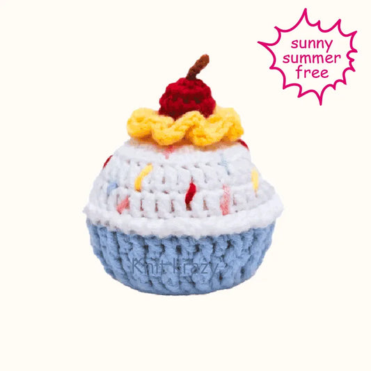 Crochet cupcake amigurumi pattern with blue base, white frosting, yellow ruffle, and red cherry on top