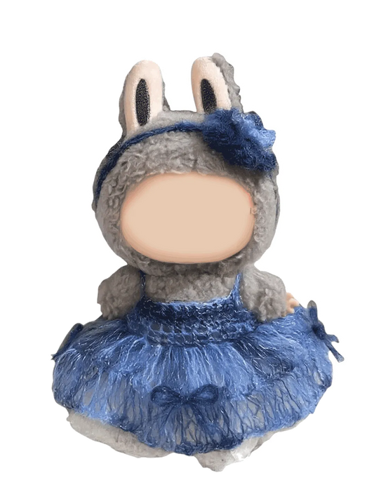 Handmade crochet doll wearing a blue crochet doll dress pattern with a flower headband and bunny ears