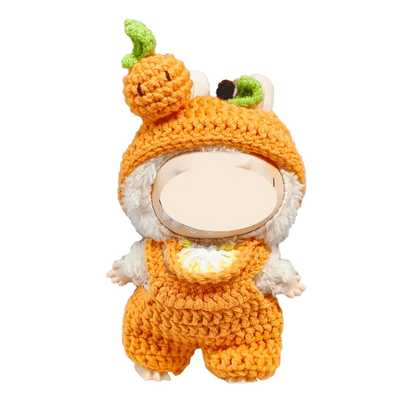 Crochet orange plush outfit pattern on a white stuffed animal with pumpkin hat and overalls