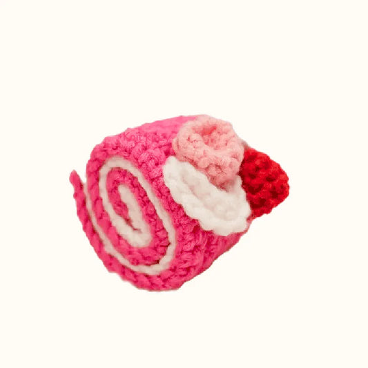 Crochet raspberry swiss roll pattern handmade pink and white rolled cake with red raspberry decoration