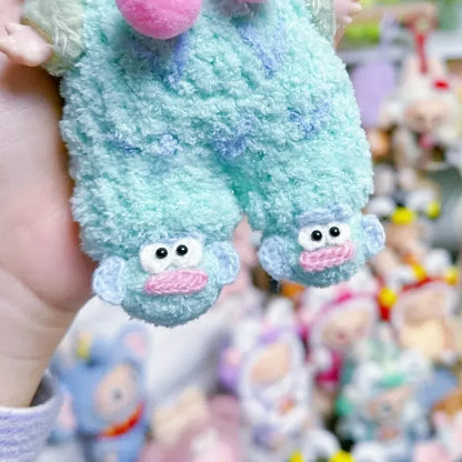 DIY crochet shoes for 17cm plush in light blue with cute monkey faces held by hand