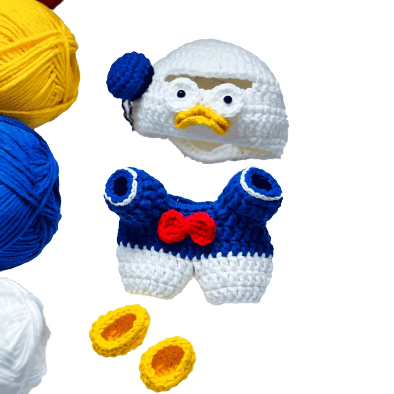 Donald Duck crochet pattern featuring white hat with blue ribbon, blue and white overalls, and yellow shoes