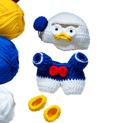 Donald Duck crochet pattern featuring white hat with blue ribbon, blue and white overalls, and yellow shoes