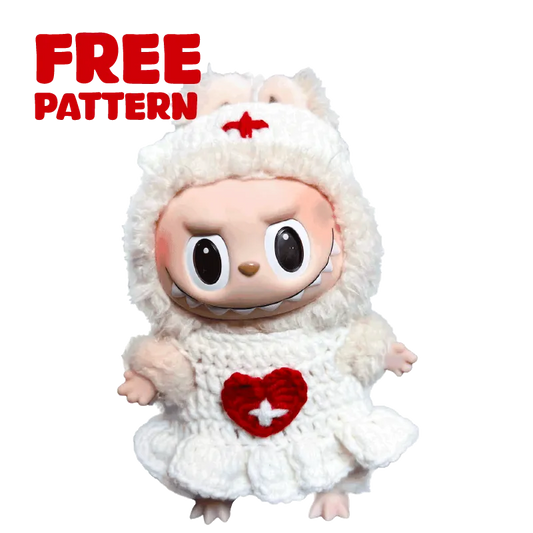 Soft toy wearing a white handmade crochet nurse outfit with red cross heart detail free crochet nurse outfit pattern 17cm