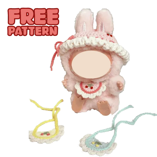 Cute plush doll wearing colorful crochet hat and pink overalls with FREE|plush toy hat and bib crochet tutorial