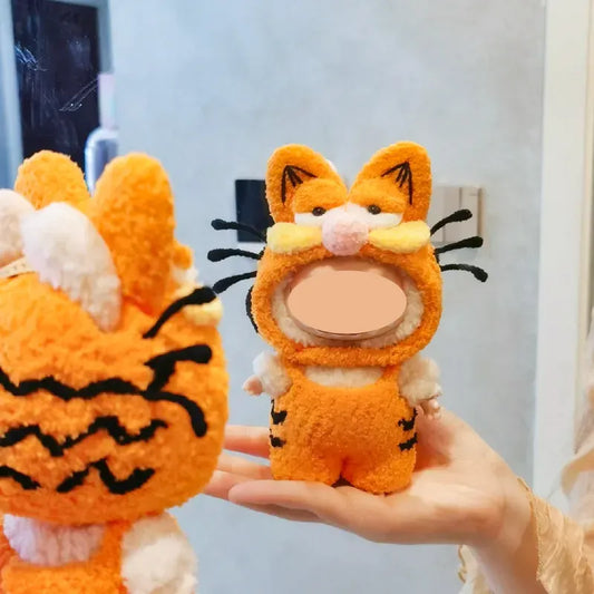 Garfield-inspired crochet pattern for dolls featuring an orange cat costume with black stripes and whiskers