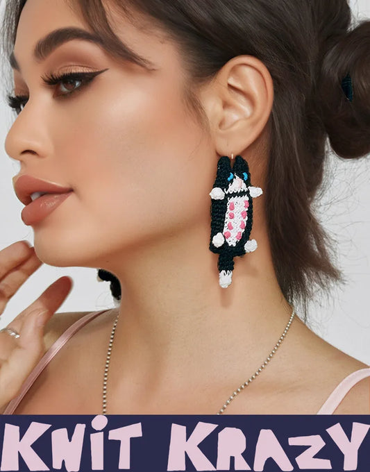 Handmade cat earrings with colorful yarn eye design worn by woman with high ponytail and natural makeup