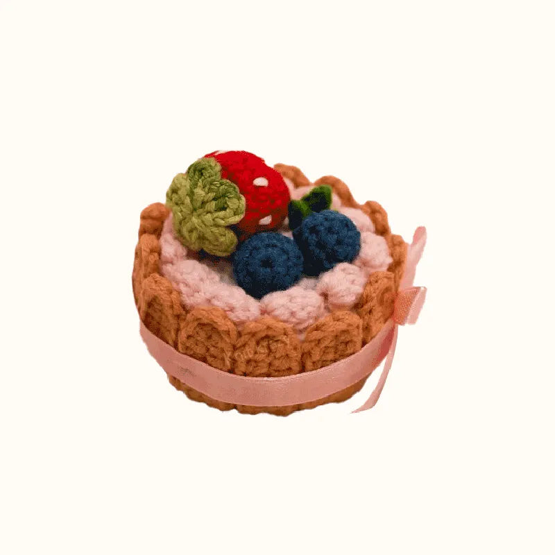 Handmade crochet biscuit cake with berries and pink ribbon using crochet biscuit cake pattern