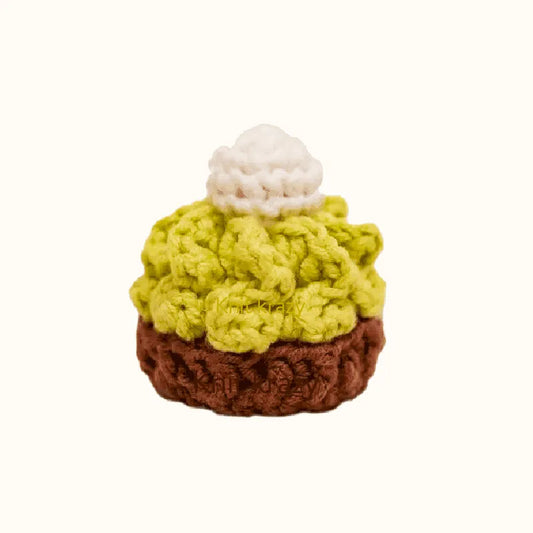 Small crochet matcha cake pattern with green frosting and a white dollop on top