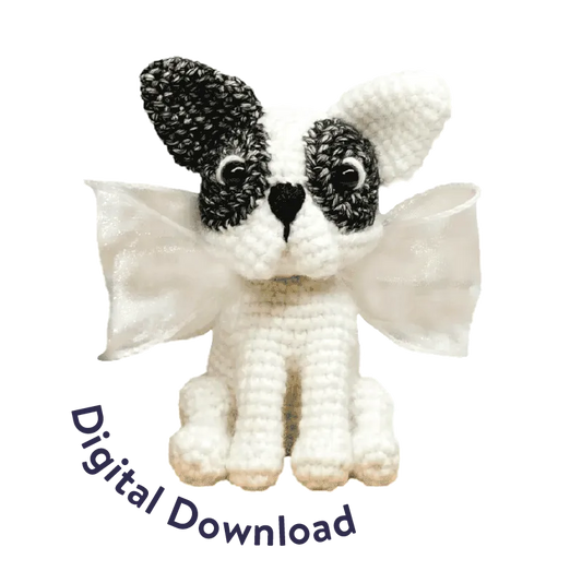 Crochet French bulldog pattern amigurumi with black and white yarn and decorative wings