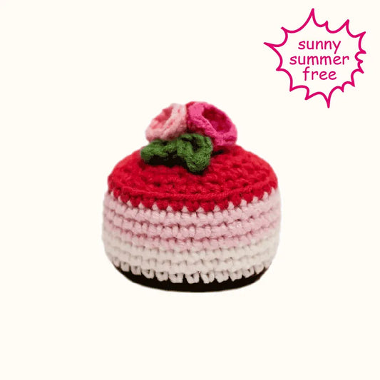 Raspberry mousse crochet tutorial by The Knit Krazy featuring a red and pink crocheted dessert with green leaves