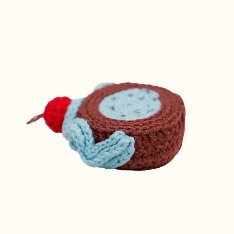 Realistic swiss roll crochet in brown with blue and red yarn details by The Knit Krazy