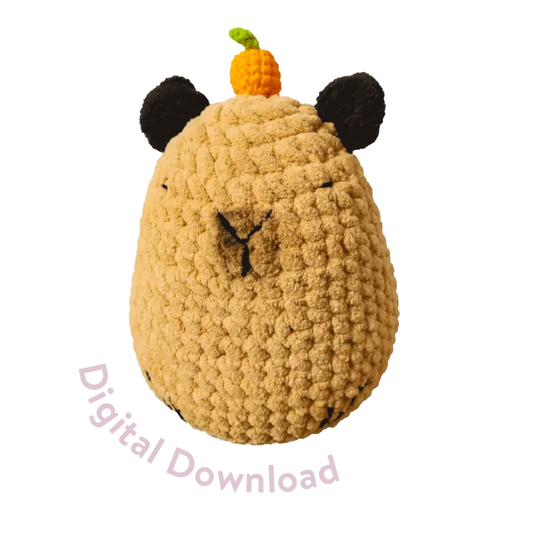 Round capybara crochet soft toy pattern in tan with black ears and orange pumpkin on top digital download