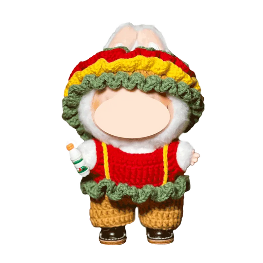Handmade knitted bunny doll wearing colorful ruffle hat and red sweater holding a small bottle