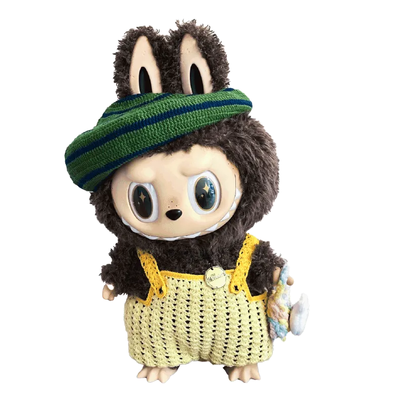 Zimomo crochet outfit pattern featured on a plush toy wearing a yellow crocheted dress and green striped hat