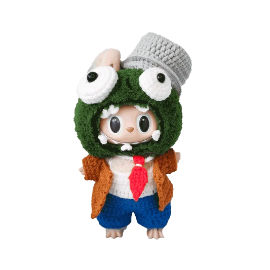 Cute doll wearing a handmade zombie crochet doll outfit pattern with green headgear and blue shorts